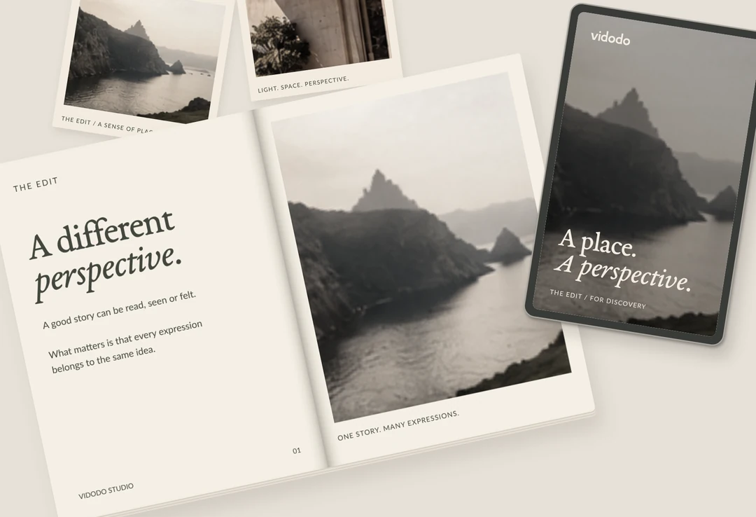 Printed travel editorial pages and photography arranged on a desk